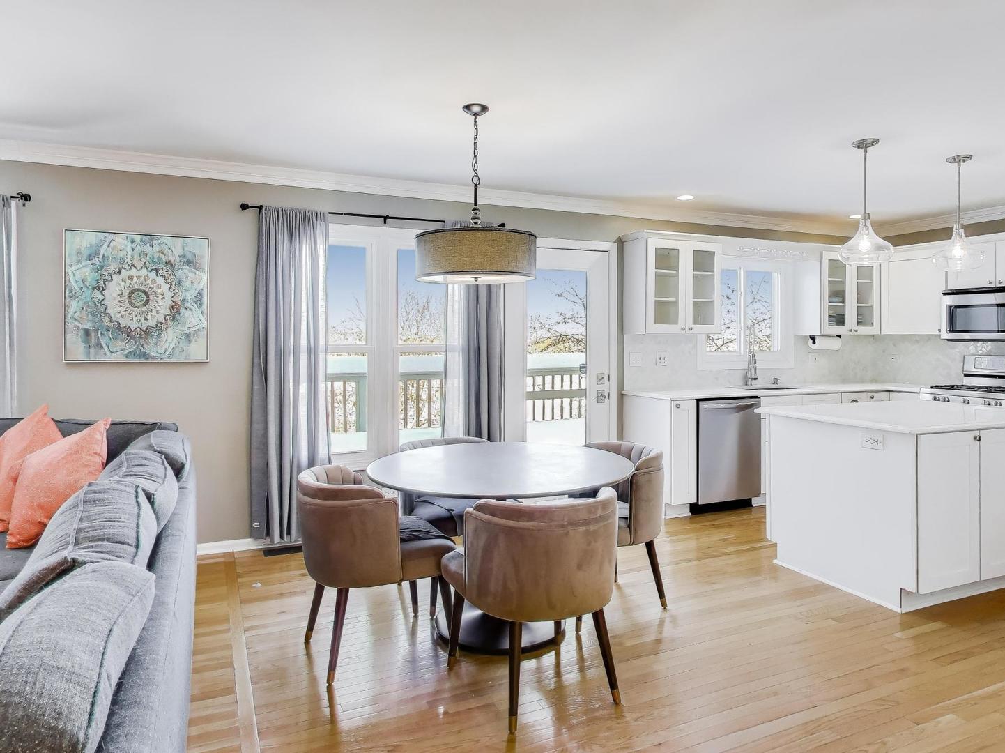 660 Robin Ridge Elgin, IL 60123 - Photo 9 of 29 a dining room with furniture a chandelier and wooden floor