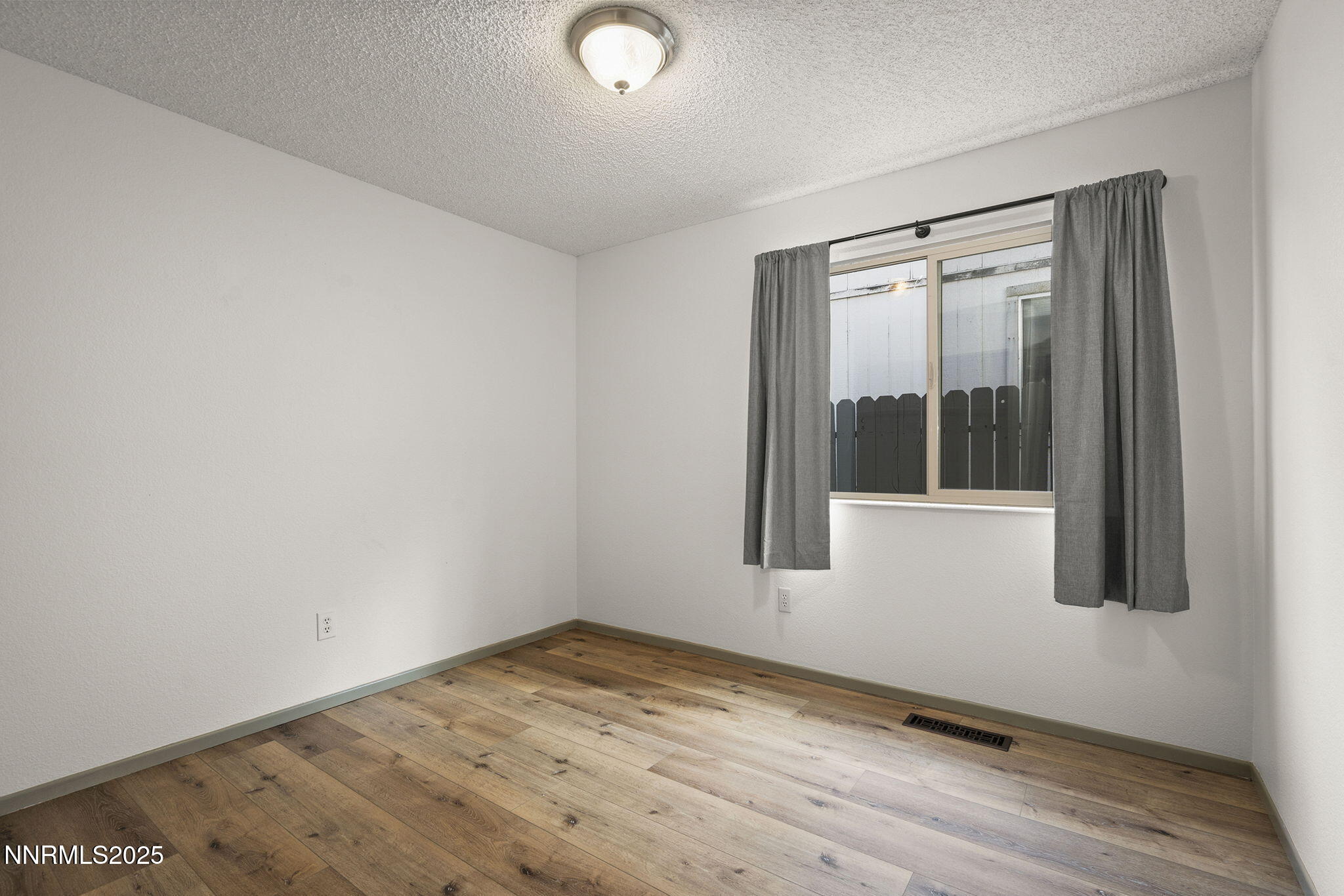 7690 Deep Bay Drive Reno, NV 89506 - Photo 19 of 26 an empty room with wooden floor and windows