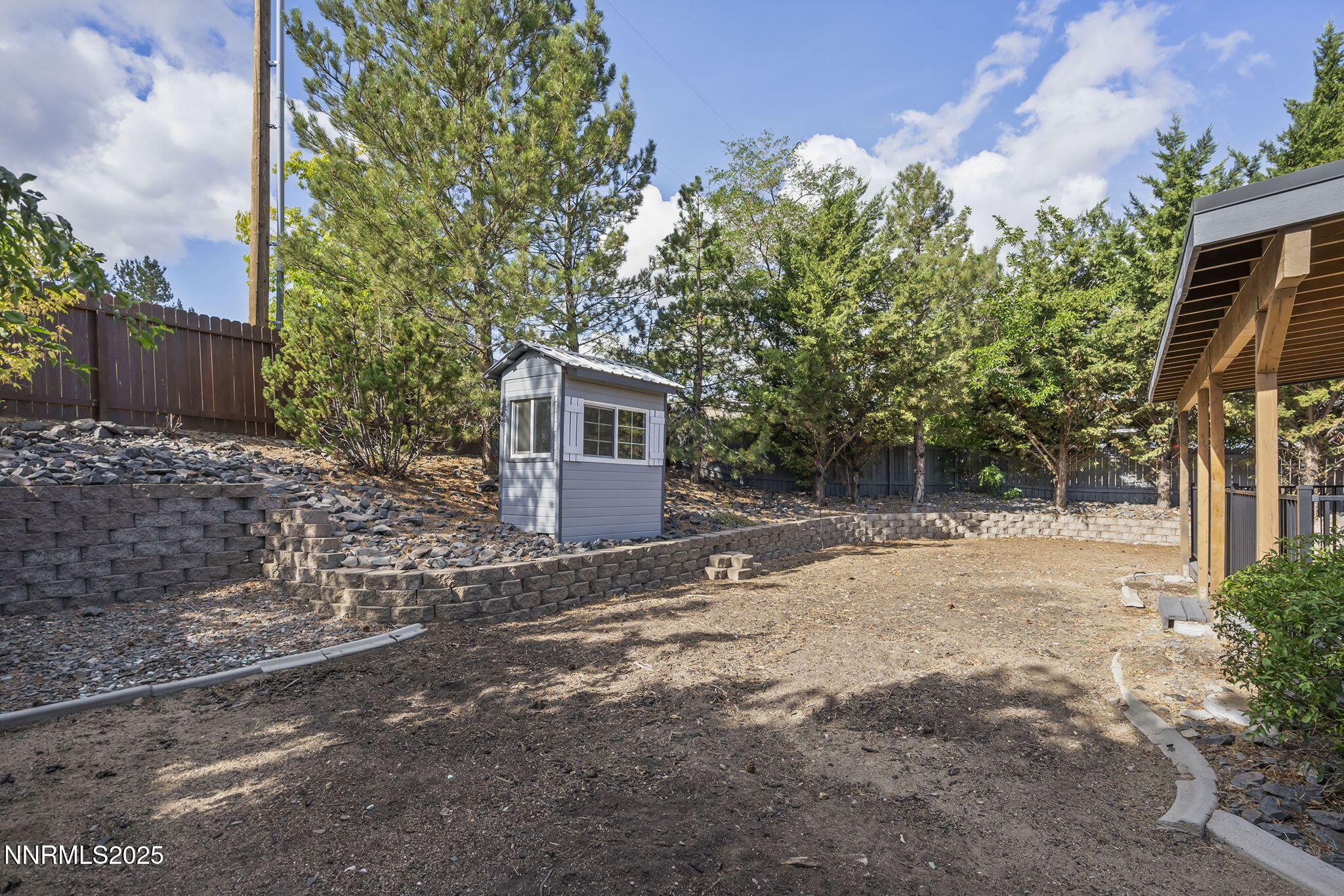7690 Deep Bay Drive Reno, NV 89506 - Photo 23 of 26 a backyard of a house with plants and trees