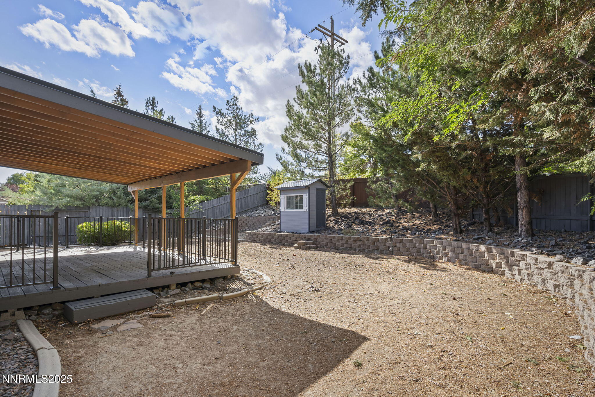 7690 Deep Bay Drive Reno, NV 89506 - Photo 24 of 26 a backyard of a house with barbeque oven and trees