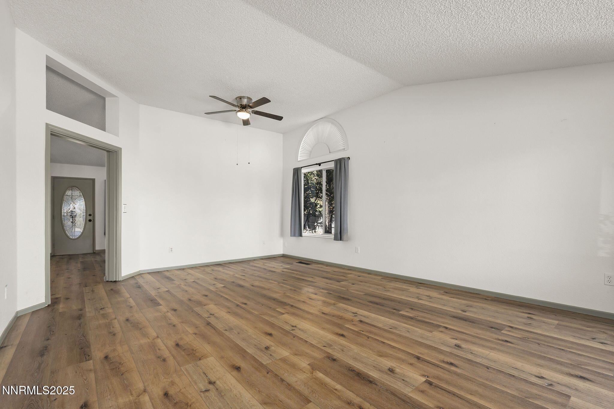 7690 Deep Bay Drive Reno, NV 89506 - Photo 5 of 26 a view of an empty room with window and wooden floor