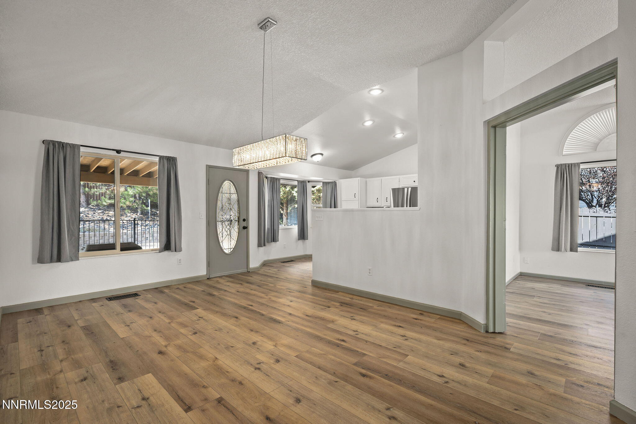 7690 Deep Bay Drive Reno, NV 89506 - Photo 6 of 26 a view of an empty room with wooden floor and a window