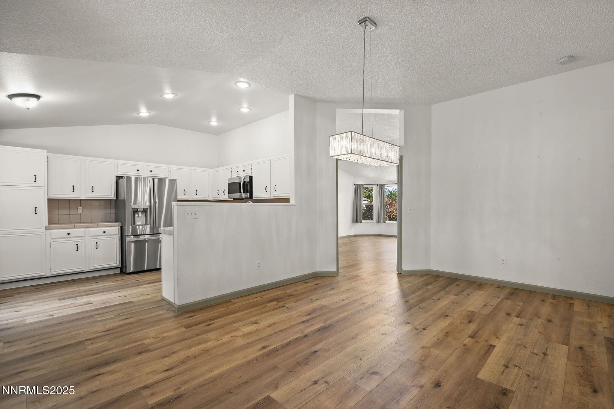 7690 Deep Bay Drive Reno, NV 89506 - Photo 7 of 26 a view of a kitchen with wooden floor and a window