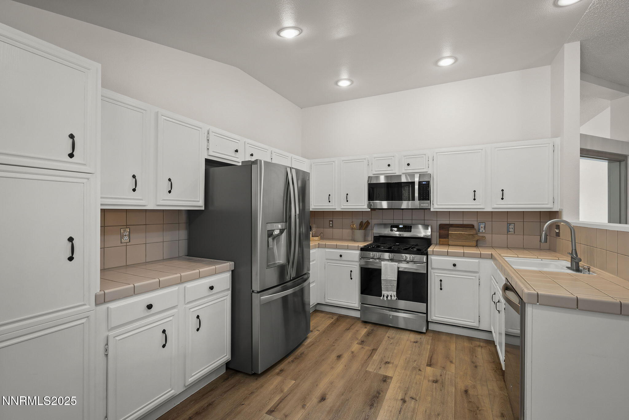 7690 Deep Bay Drive Reno, NV 89506 - Photo 8 of 26 a kitchen with cabinets stainless steel appliances and sink