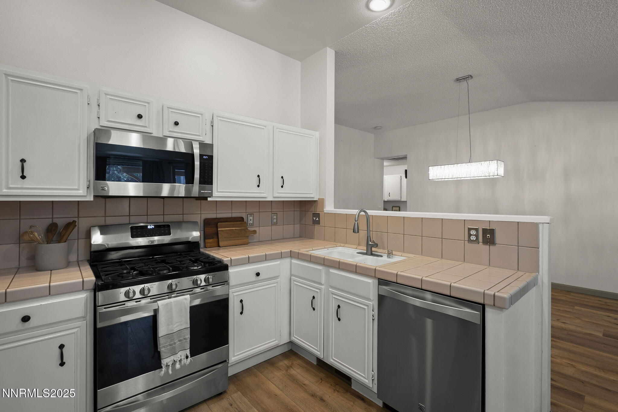 7690 Deep Bay Drive Reno, NV 89506 - Photo 9 of 26 a kitchen with a sink stove and microwave