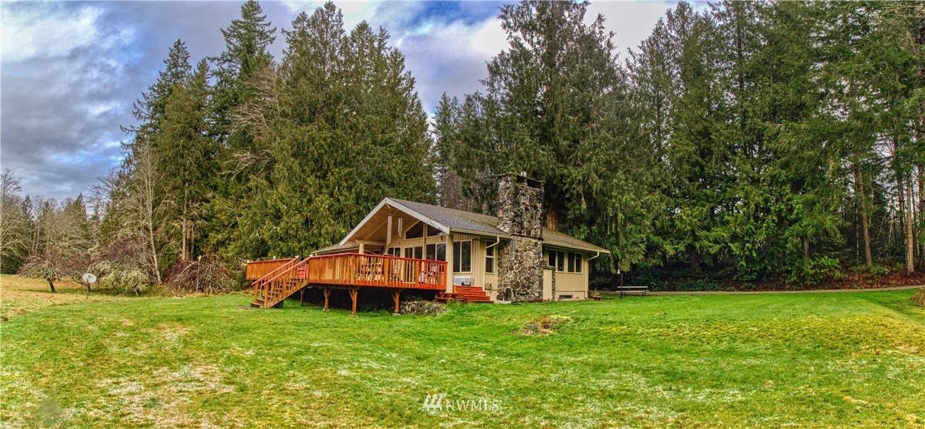 991 Lords Lake Loop Road Quilcene, WA 98376 - Photo 2 of 34 a front view of a house with garden