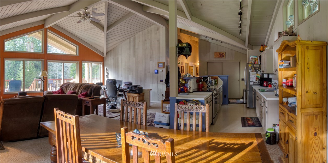 991 Lords Lake Loop Road Quilcene, WA 98376 - Photo 11 of 34 a living room with lots of furniture and a chandelier