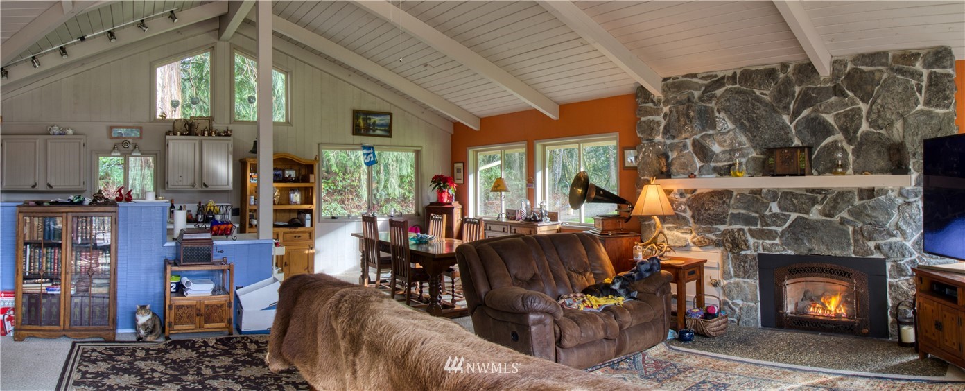 991 Lords Lake Loop Road Quilcene, WA 98376 - Photo 12 of 34 a living room with furniture and a fireplace
