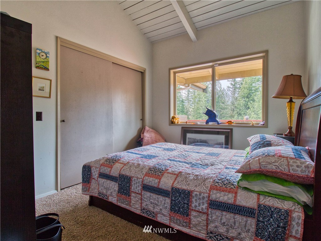 991 Lords Lake Loop Road Quilcene, WA 98376 - Photo 15 of 34 a bedroom with a bed next to a window