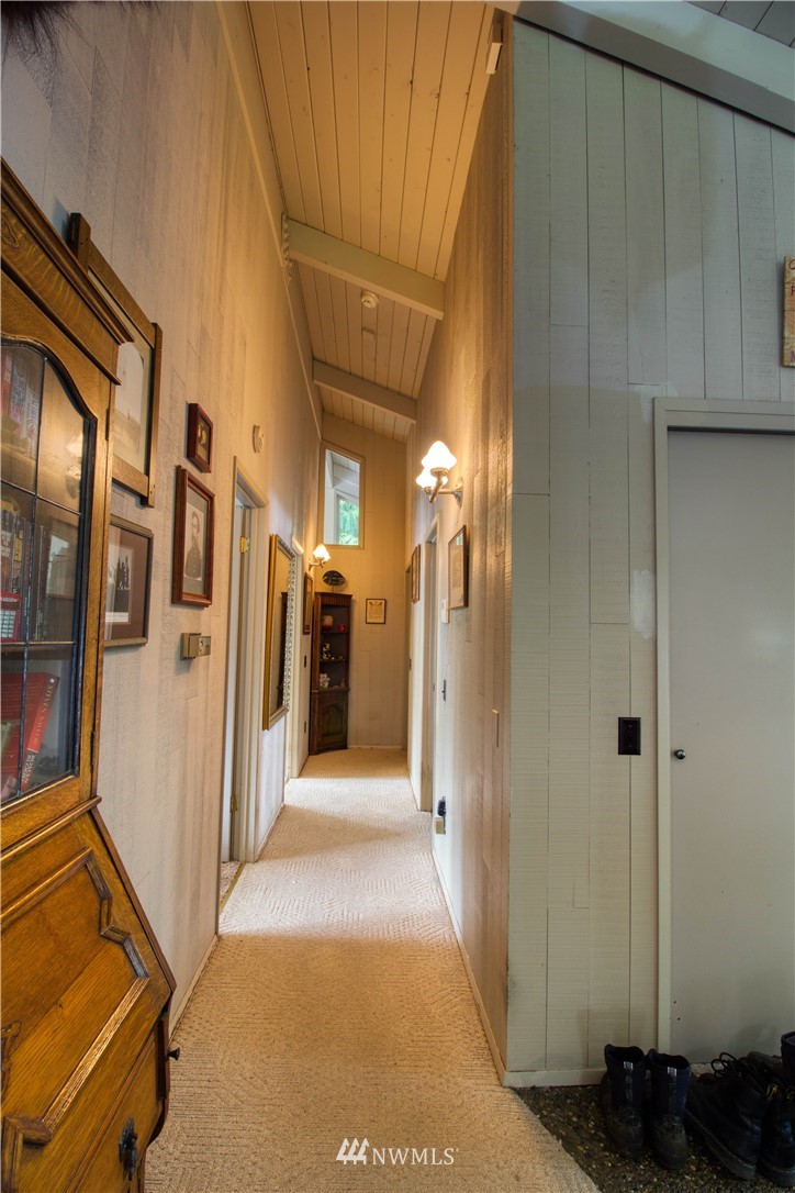 991 Lords Lake Loop Road Quilcene, WA 98376 - Photo 18 of 34 a view of a hallway with wooden cabinets