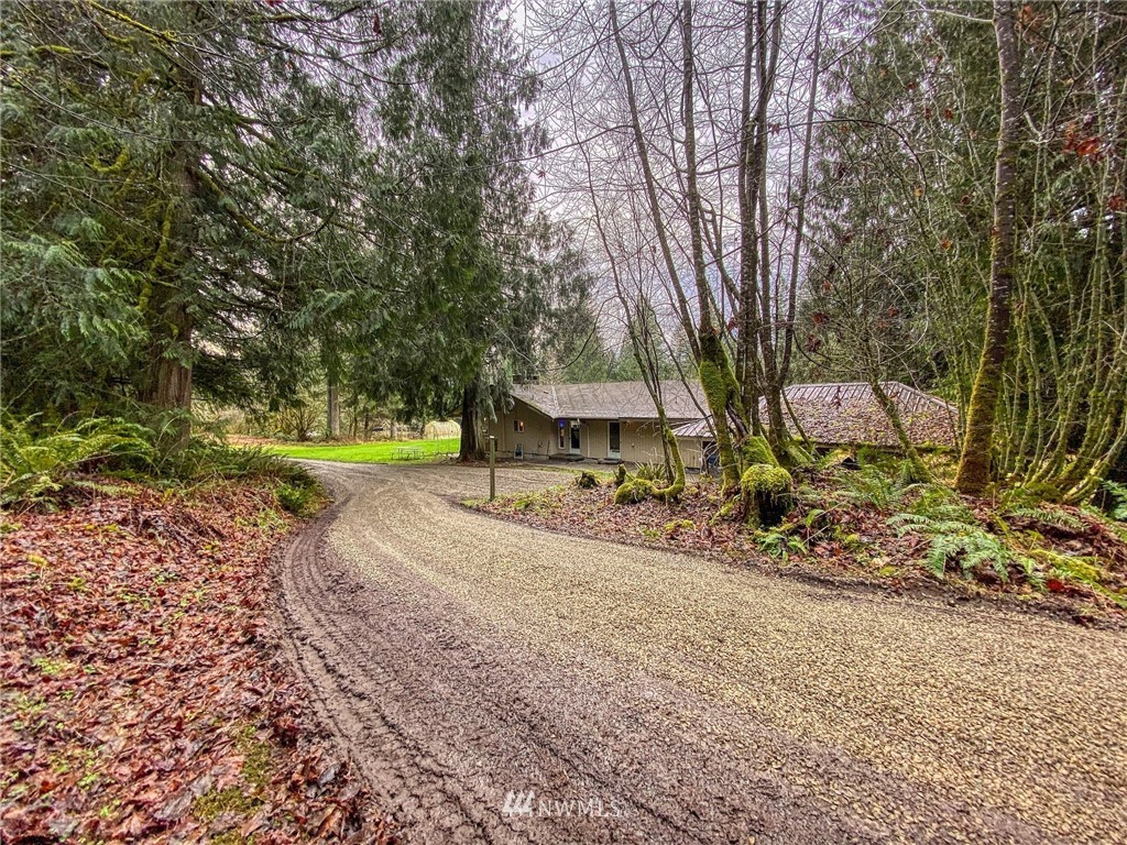 991 Lords Lake Loop Road Quilcene, WA 98376 - Photo 26 of 34 a view of a park with a bench and some trees