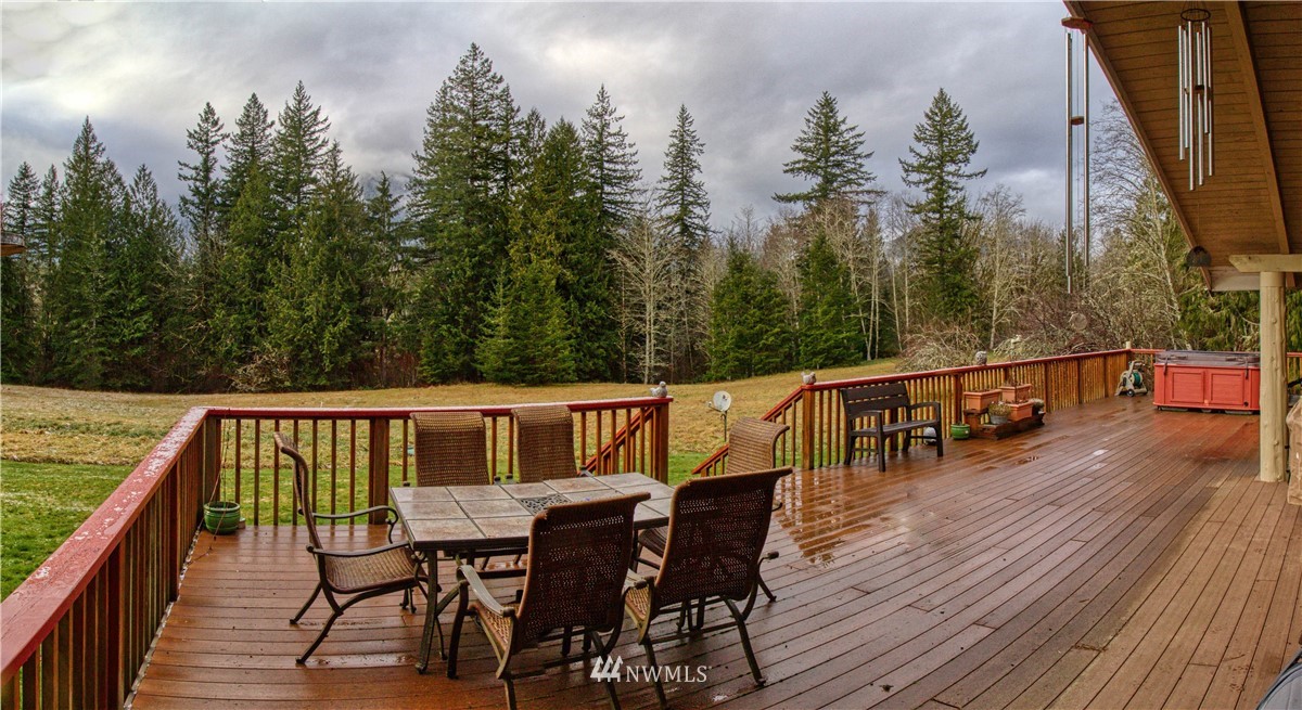991 Lords Lake Loop Road Quilcene, WA 98376 - Photo 4 of 34 a view of a chairs and table on the wooden floor