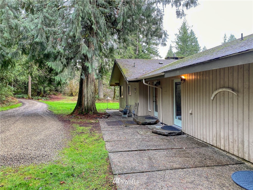 991 Lords Lake Loop Road Quilcene, WA 98376 - Photo 33 of 34 a front view of a house with a yard