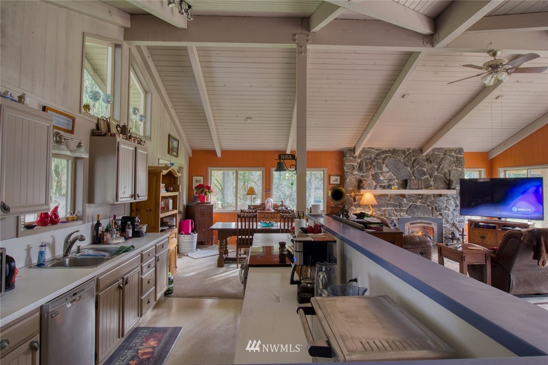 991 Lords Lake Loop Road Quilcene, WA 98376 - Photo 10 of 34 a view of a kitchen with a large window and sitting area