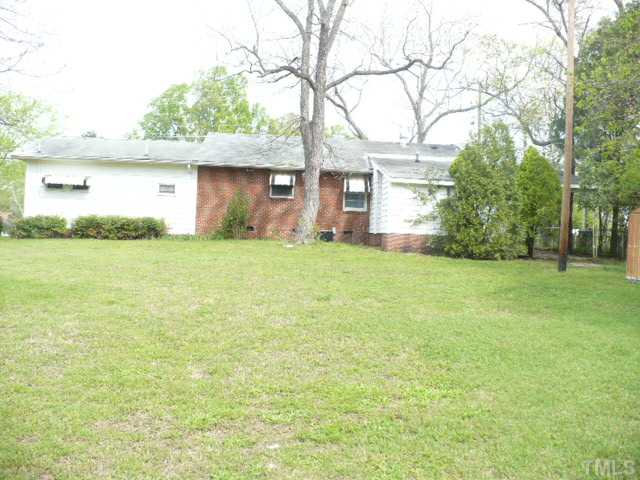 2828 Poole Road Raleigh, NC 27610 - Photo 17 of 18 a front view of a house with a yard and garage