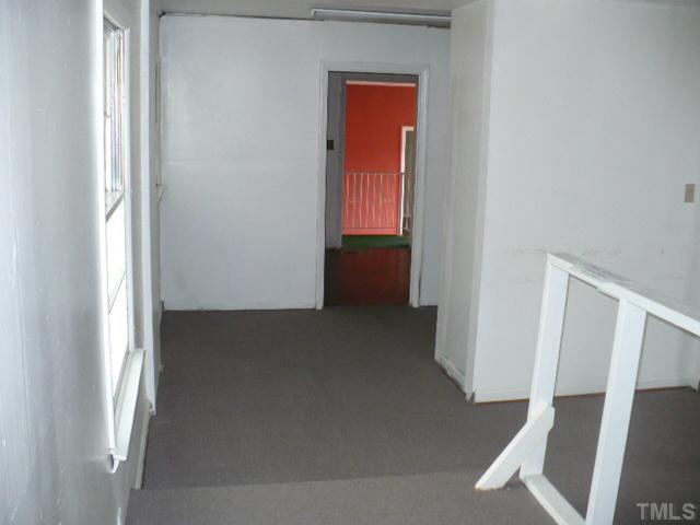 2828 Poole Road Raleigh, NC 27610 - Photo 3 of 18 a view of an empty room with wooden floor