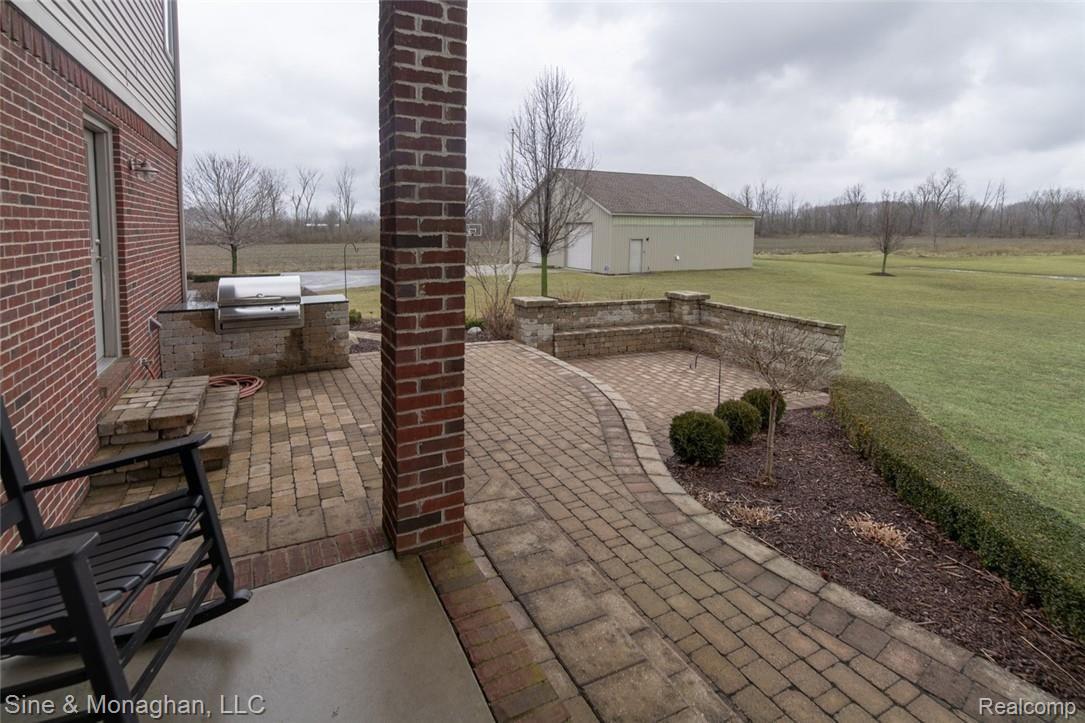 9722 Springborn Road Casco, MI 48064 - Photo 42 of 54 Covered porch, patio, built in grille & benches