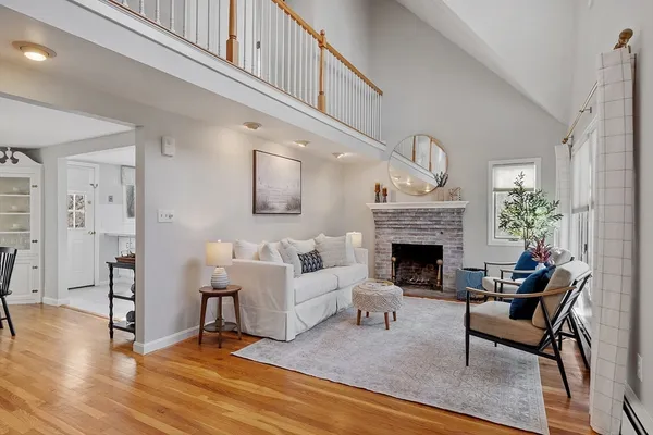 a living room with furniture a fireplace and a table