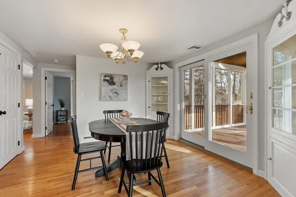 a view of a dining room with furniture wooden floor and chandelier
