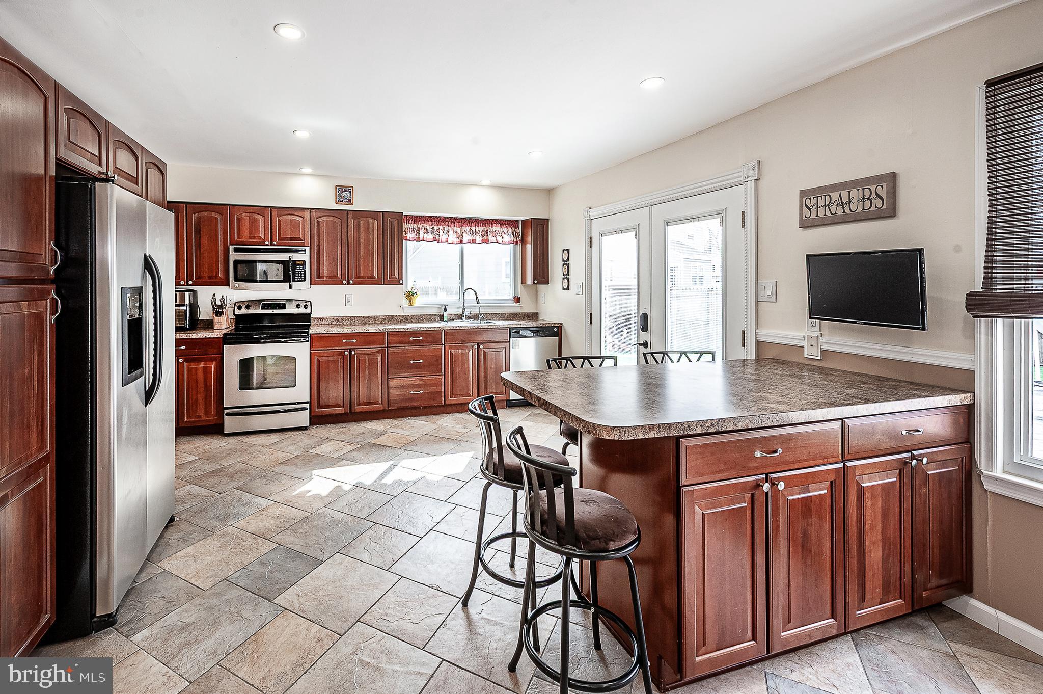 48 Aristone Drive Berlin, NJ 08009 - Photo 14 of 34 a kitchen with stainless steel appliances granite countertop a stove refrigerator sink and microwave
