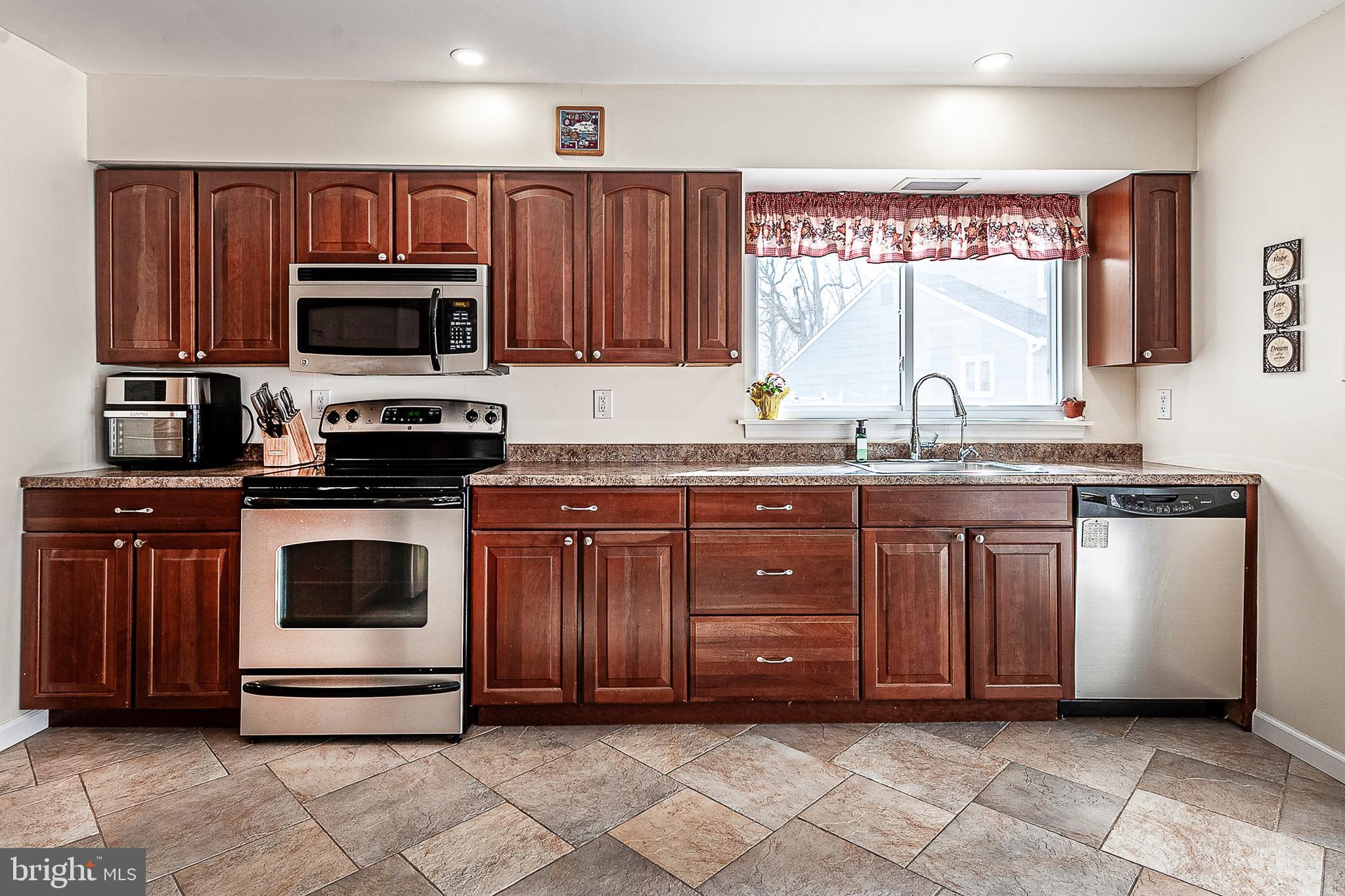 48 Aristone Drive Berlin, NJ 08009 - Photo 15 of 34 a kitchen with granite countertop a sink and cabinets