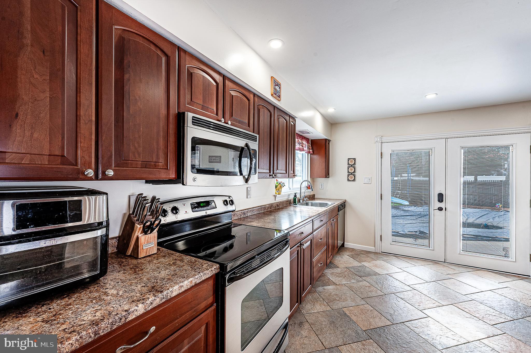 48 Aristone Drive Berlin, NJ 08009 - Photo 16 of 34 a kitchen with stainless steel appliances granite countertop a stove and a refrigerator