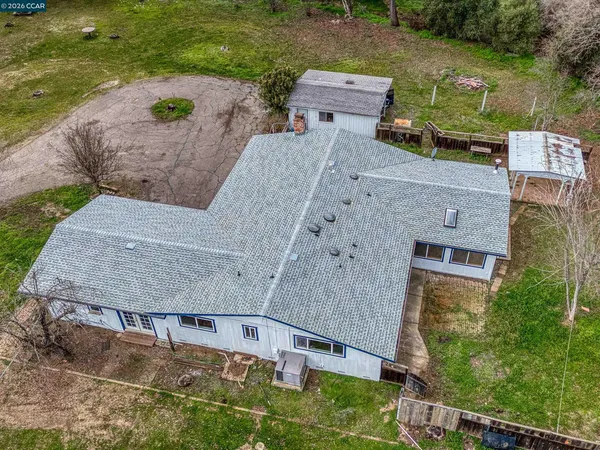 an aerial view of a house with a yard