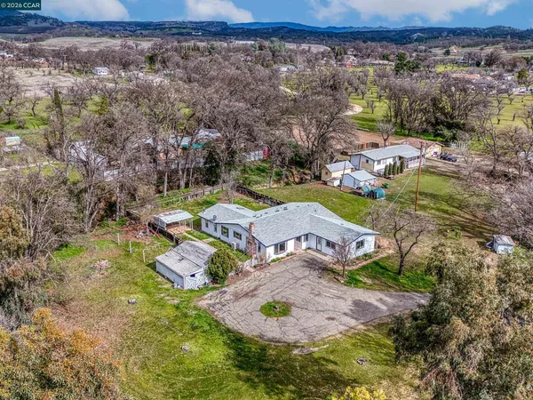 an aerial view of a house with a yard