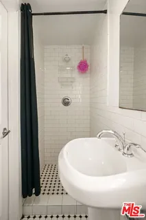 a bathroom with a bathtub and shower