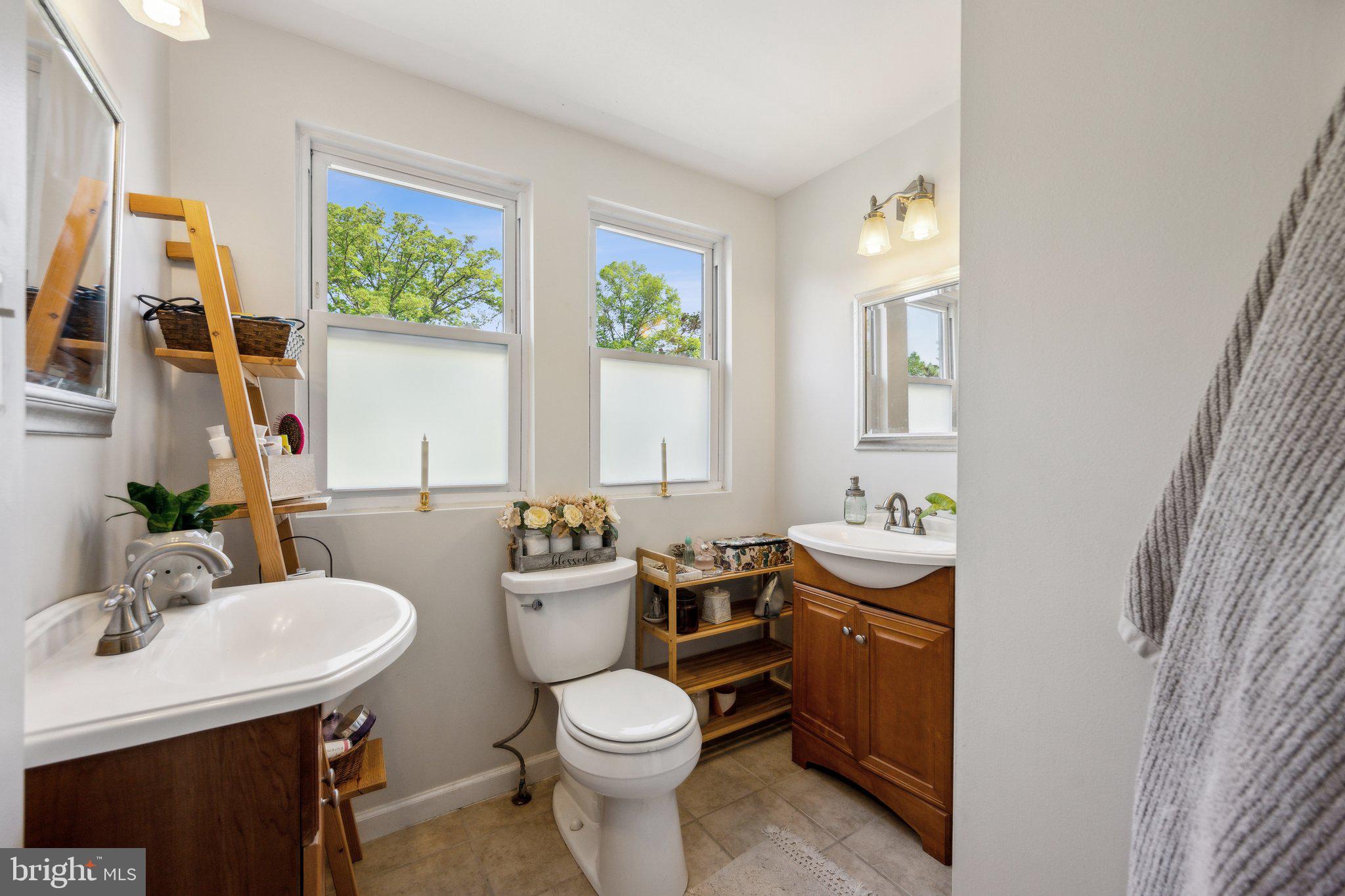 8116 Beverly Road Severn, MD 21144 - Photo 19 of 24 a bathroom with a toilet a sink and a mirror