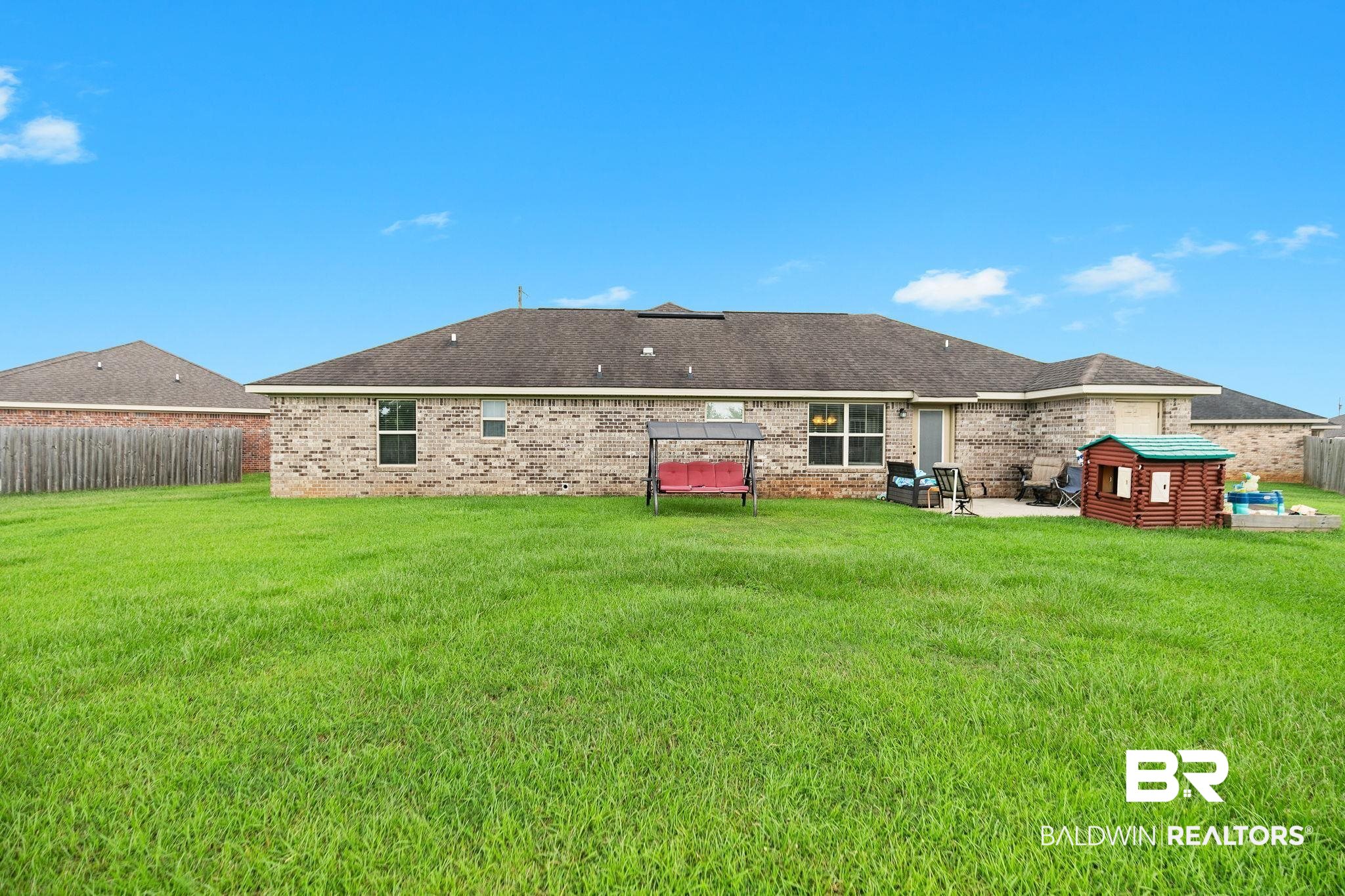 15573 Talus Court Foley, AL 36535 - Photo 36 of 50 Back of house with a patio area and a lawn