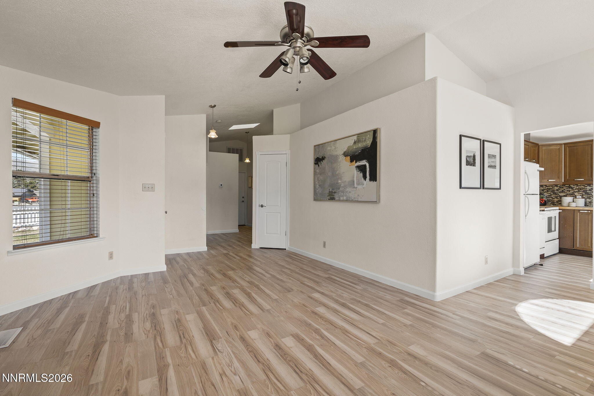 6290 Chesterfield Lane Reno, NV 89523 - Photo 11 of 21 a view of empty room with wooden floor and fan