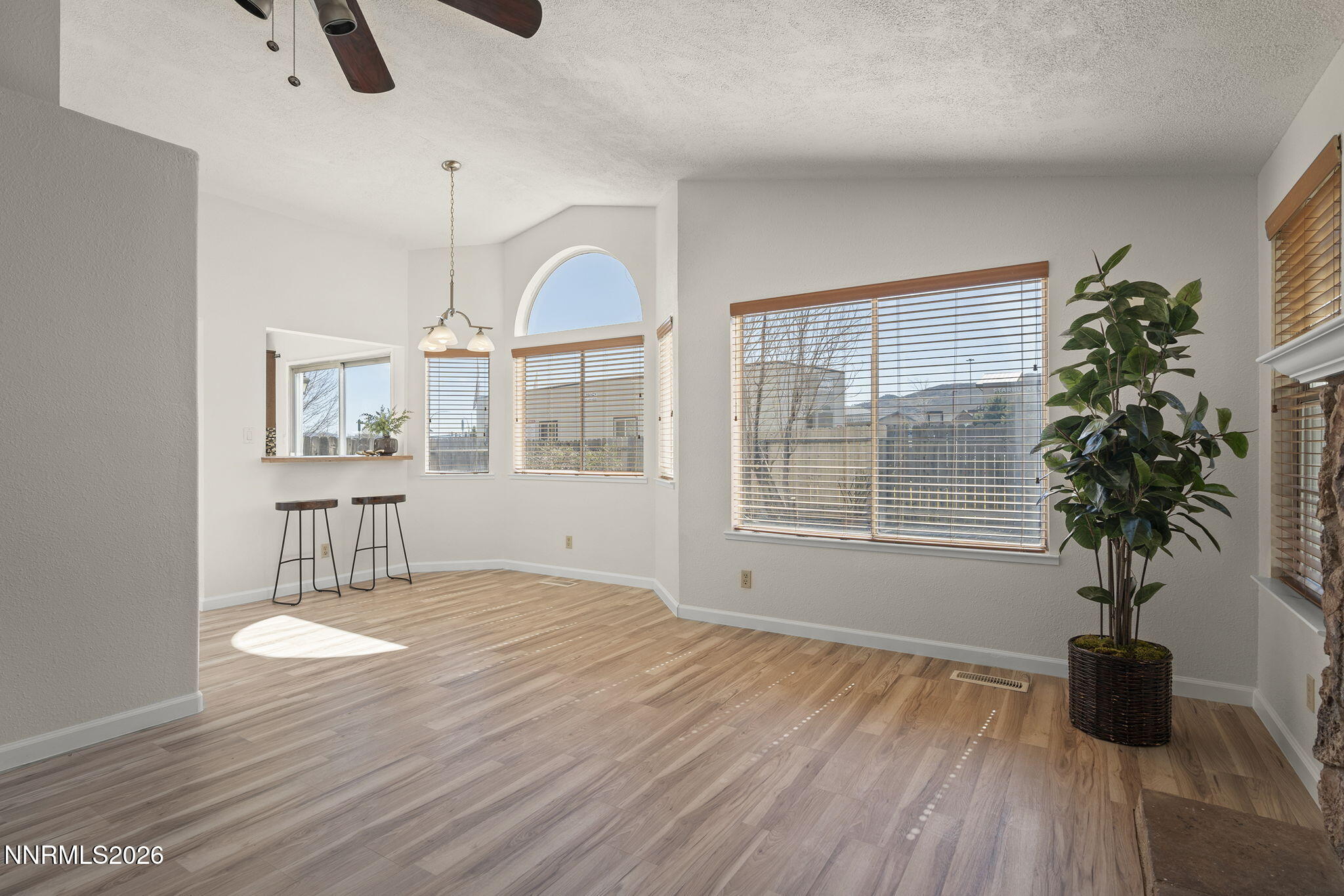 6290 Chesterfield Lane Reno, NV 89523 - Photo 12 of 21 a view of an empty room with a window and wooden floor