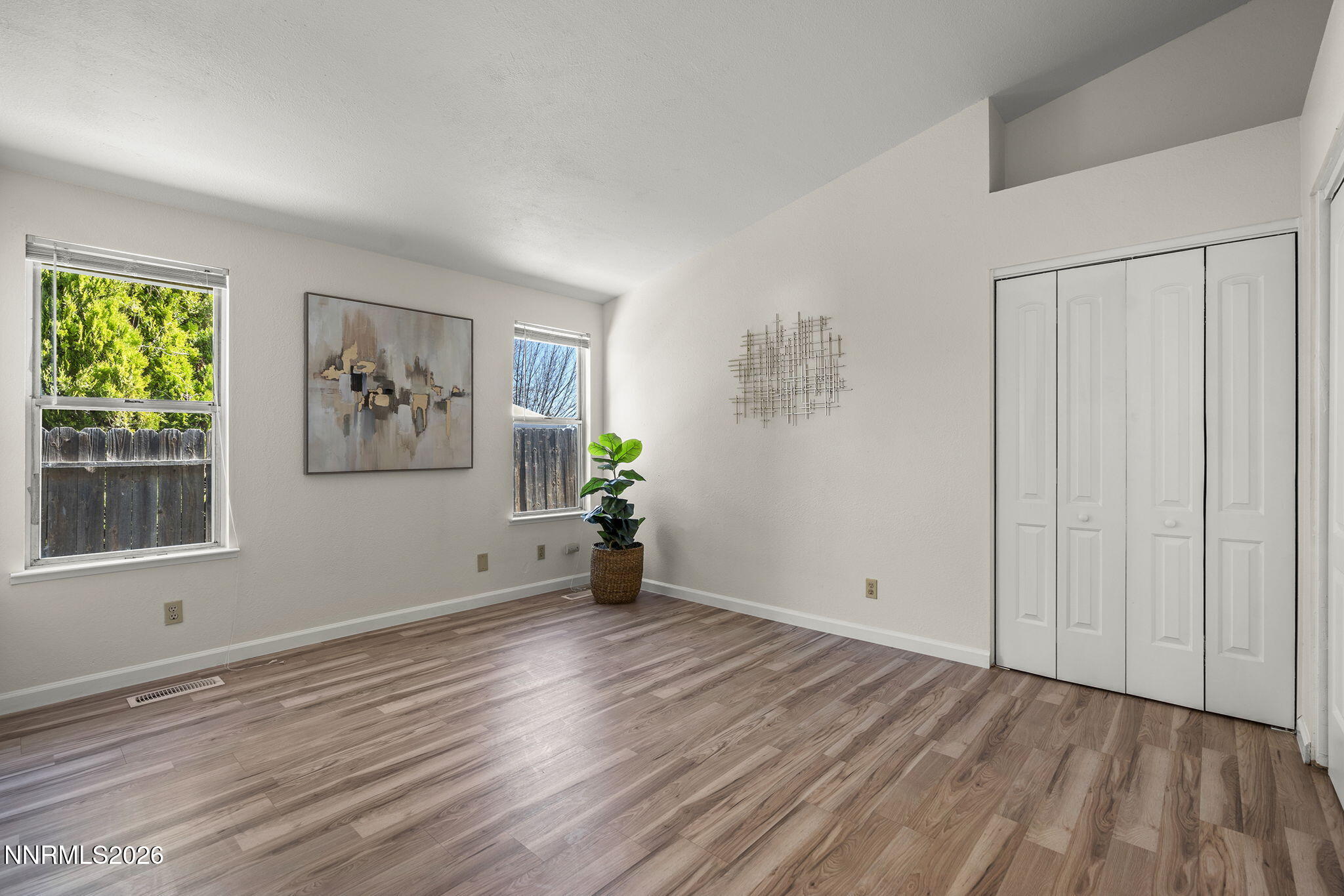6290 Chesterfield Lane Reno, NV 89523 - Photo 13 of 21 a view of empty room with wooden floor and fan