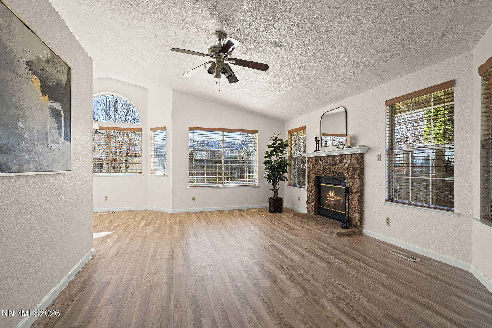 6290 Chesterfield Lane Reno, NV 89523 - Photo 8 of 21 a view of a livingroom with furniture wooden floor fireplace and windows