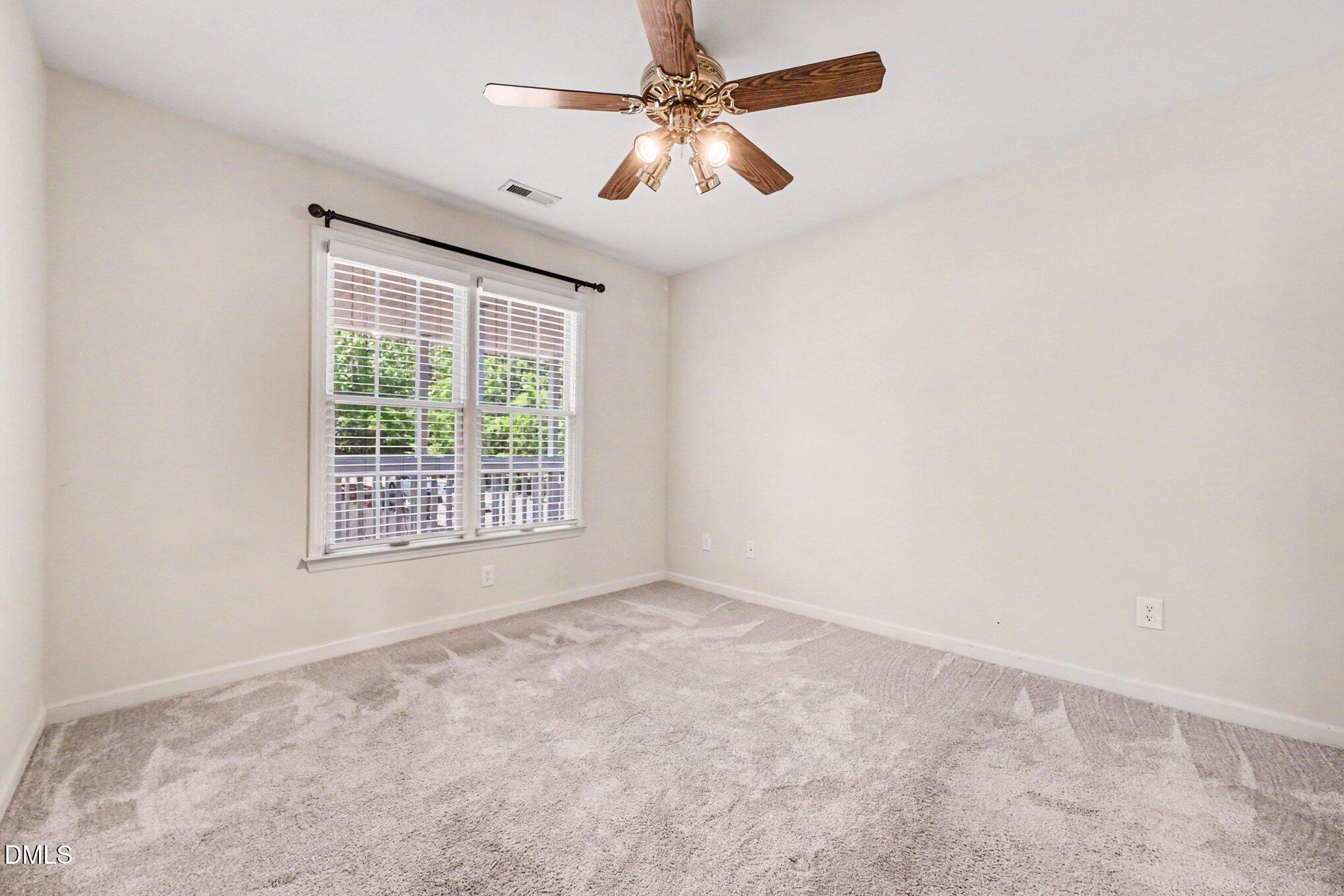 132 Springfork Drive Cary, NC 27513 - Photo 27 of 28 an empty room with windows and fan
