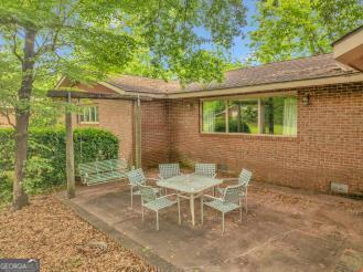 111 Roberson Street Dublin, GA 31021 - Photo 13 of 15 a view of a chair and table in backyard of the house