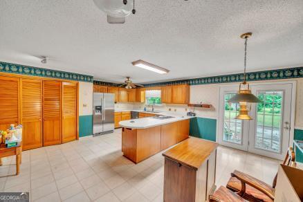 111 Roberson Street Dublin, GA 31021 - Photo 6 of 15 a kitchen with a sink and large windows