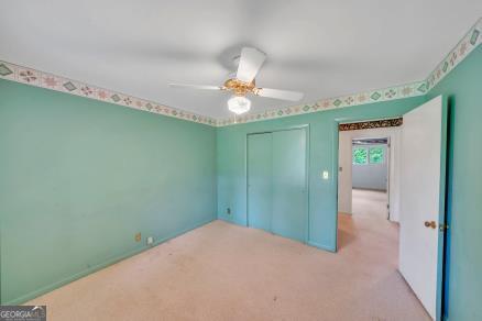 111 Roberson Street Dublin, GA 31021 - Photo 10 of 15 a bedroom with a bed and a chandelier fan