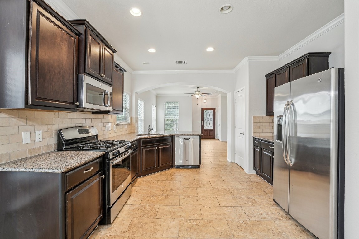 10017 Pinnacle Crest Loop Austin, TX 78747 - Photo 1 of 29 a large kitchen with stainless steel appliances granite countertop a stove a refrigerator and a sink