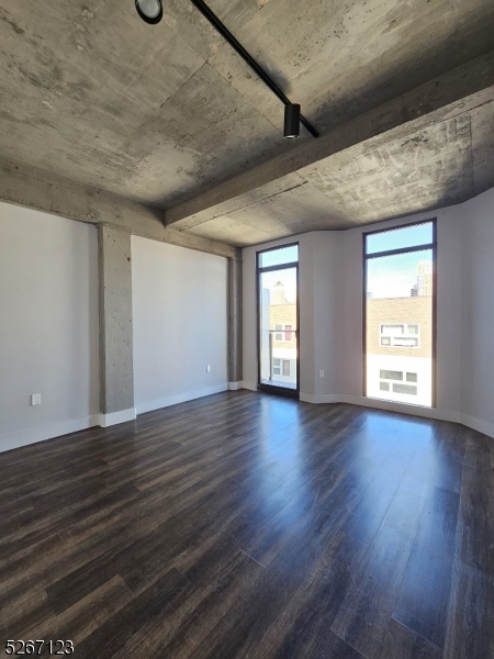 58 Elm Street, Unit 601 Newark, NJ 07105 - Photo 11 of 15 an empty room with wooden floor and windows