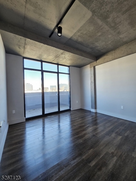 58 Elm Street, Unit 601 Newark, NJ 07105 - Photo 15 of 15 an empty room with wooden floor and sliding glass door