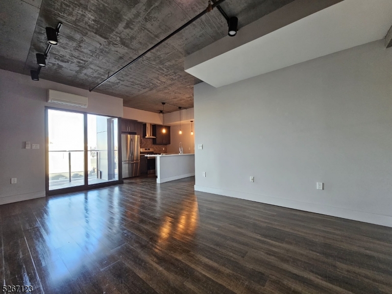 58 Elm Street, Unit 601 Newark, NJ 07105 - Photo 2 of 15 a view of empty room with wooden floor and windows