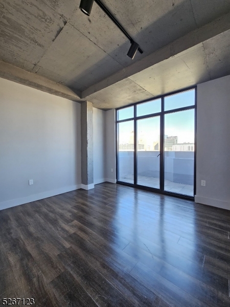 58 Elm Street, Unit 601 Newark, NJ 07105 - Photo 4 of 15 a view of an empty room with wooden floor and fan