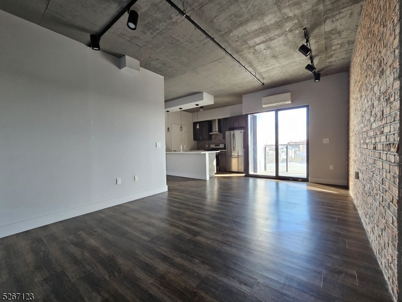 58 Elm Street, Unit 601 Newark, NJ 07105 - Photo 8 of 15 an empty room with wooden floor and windows