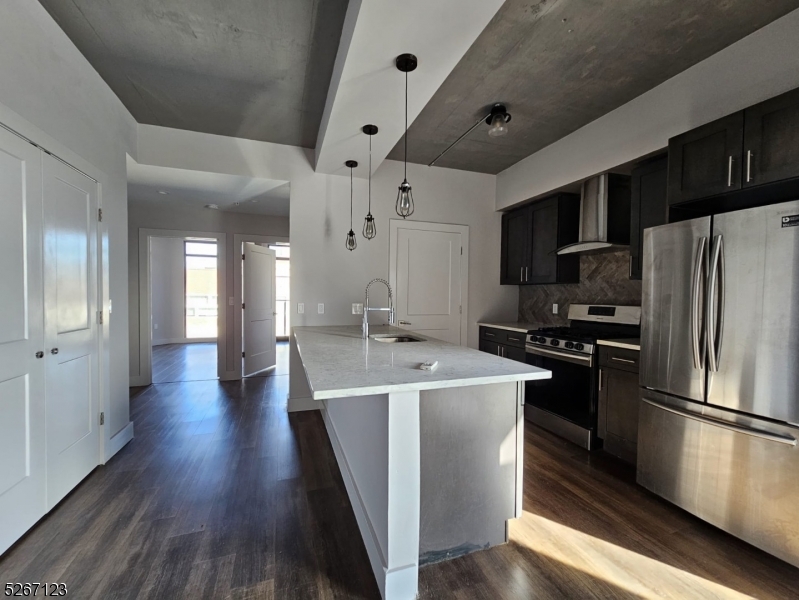58 Elm Street, Unit 601 Newark, NJ 07105 - Photo 9 of 15 a kitchen with stainless steel appliances a refrigerator and a stove