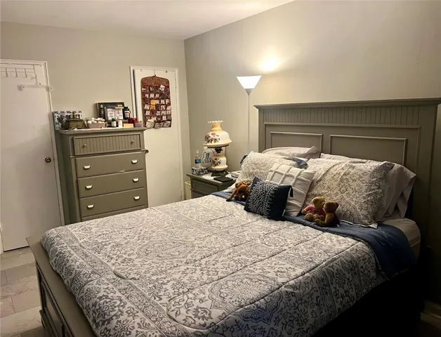 a bedroom with a bed and a dresser