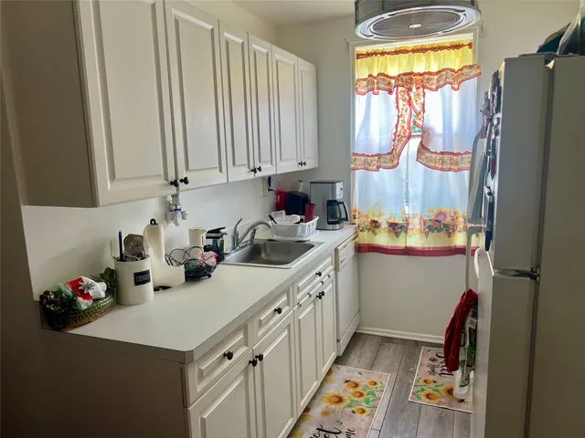 a kitchen with a sink appliances and cabinets