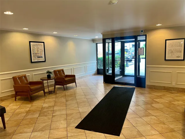 a lobby with furniture and window