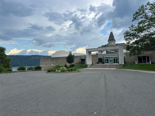a view of a tennis ground with trees